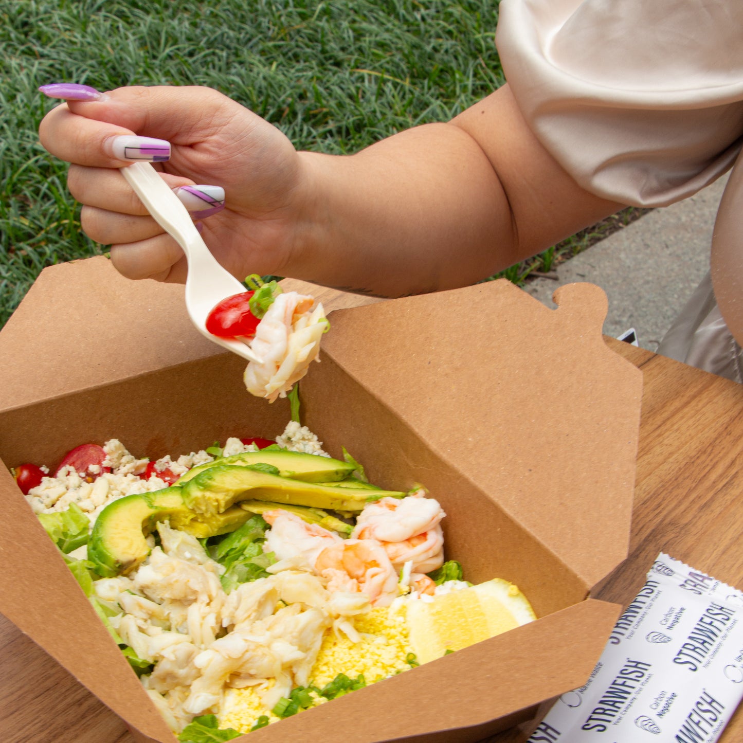 StrawFish Fork scooping a boxed salad