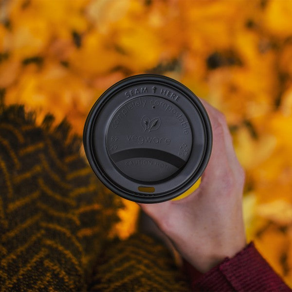 A CPLA hot cup lid. Fits 89-Series cups. A lid for hot coffees or teas to go. Made from CPLA, sleek black color, embossed with Vegware messaging. Award-winning quality by Vegware, made from plants. 